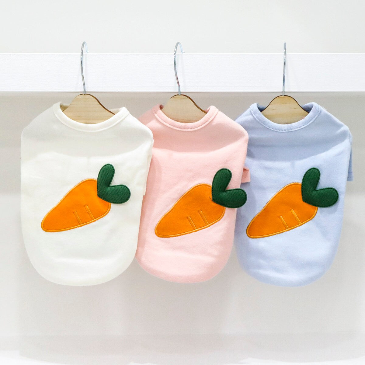 NKpup Heart Carrot Dog Shirts in white, pink, and blue with carrot patches