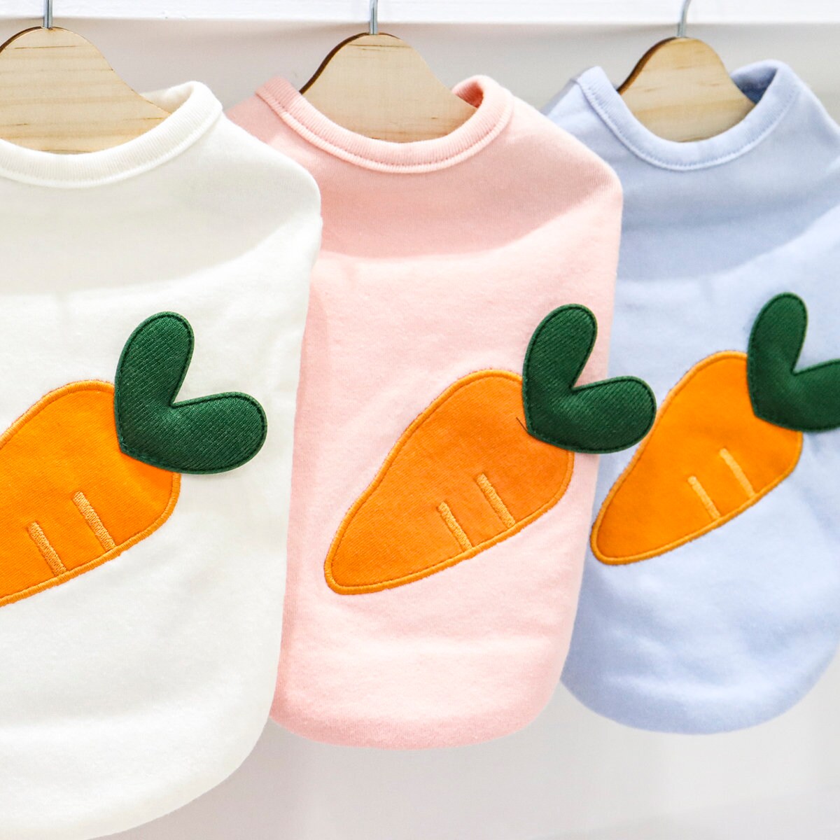 NKpup Heart Carrot Dog Shirts in white, pink, and light blue with orange carrot embroidery
