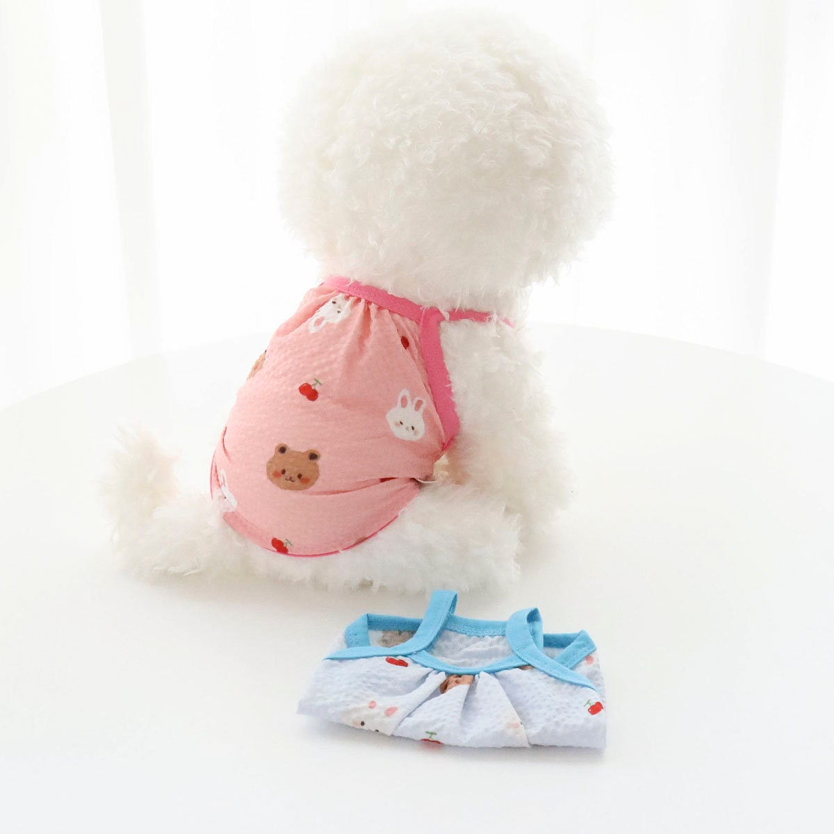 Pink Yoryu Play Top dog shirt with bear and rabbit pattern and a light blue patterned dog shirt.