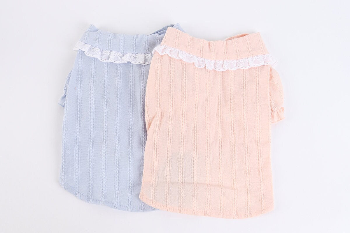 Two NKpup lace puff blouses for dogs in light blue and peach colors.
