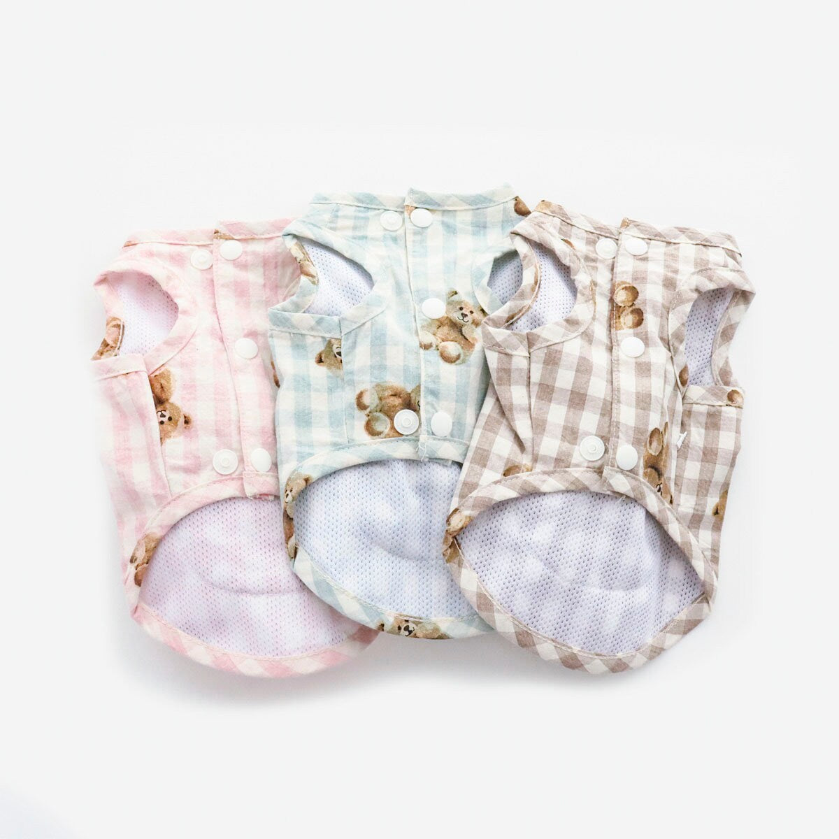 Three NKpup Teddy Bear Pocket D-Ring Dog Vests in pink, blue, and beige gingham patterns