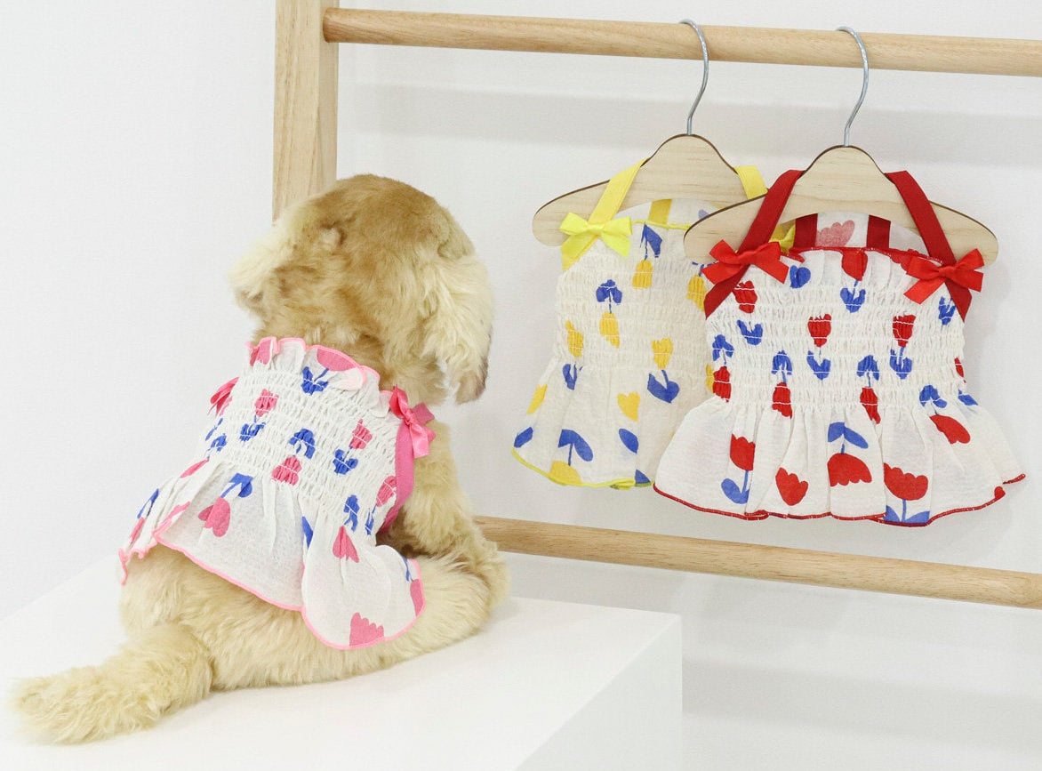 NKpup Tulip Smocked Dog Dress in white with pink and blue tulip patterns and ruffle trim.