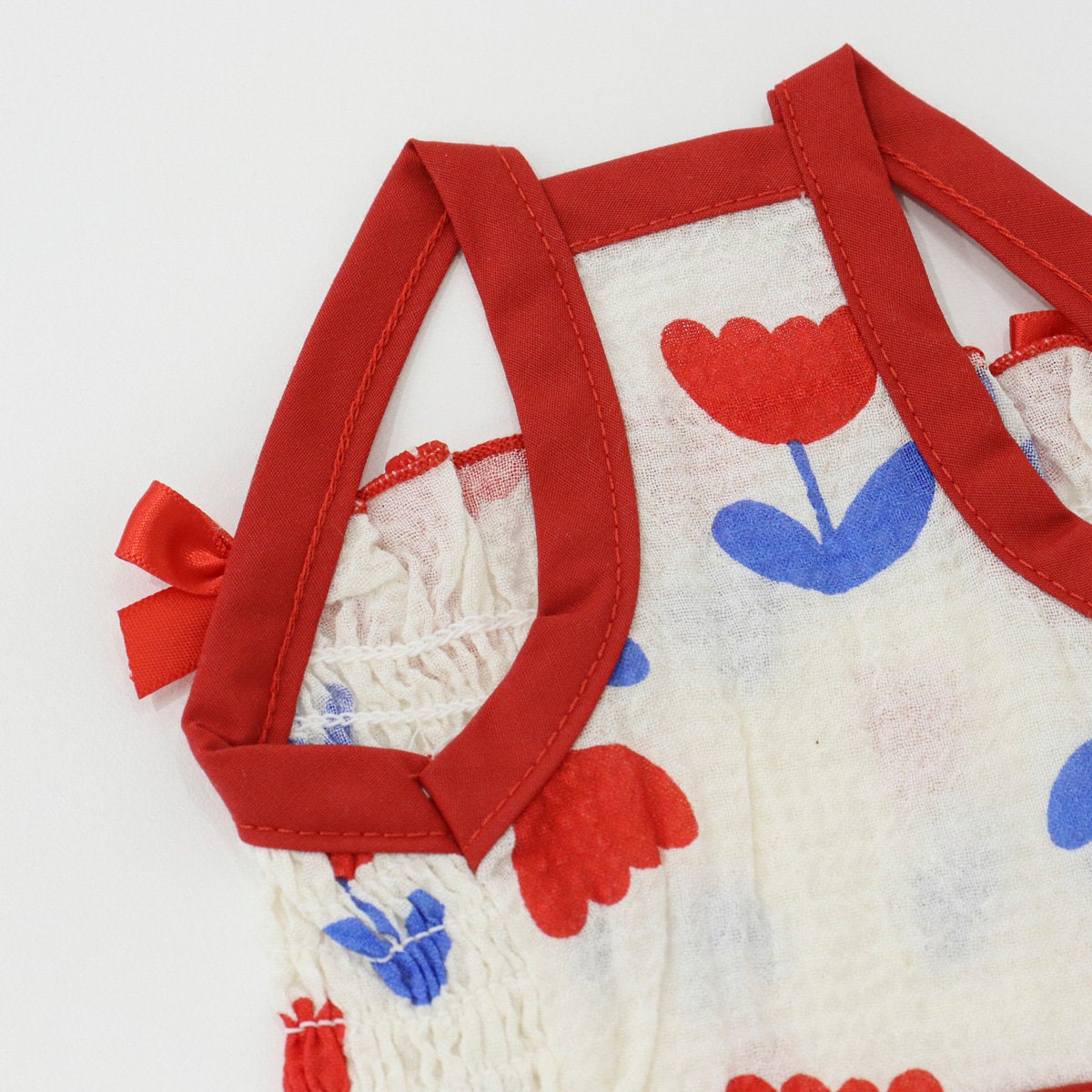 NKpup Tulip Smocked Dog Dress in white with red tulip pattern and red straps