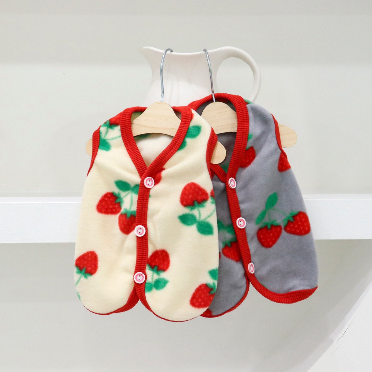 NKpup Strawberry Boa Fleece Dog Vest in cream and grey with red strawberry pattern.