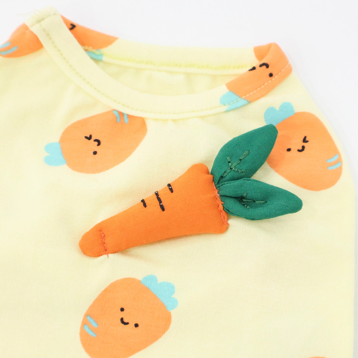 Yellow NKpup dog shirt featuring a carrot print and a 3D carrot plush accessory.