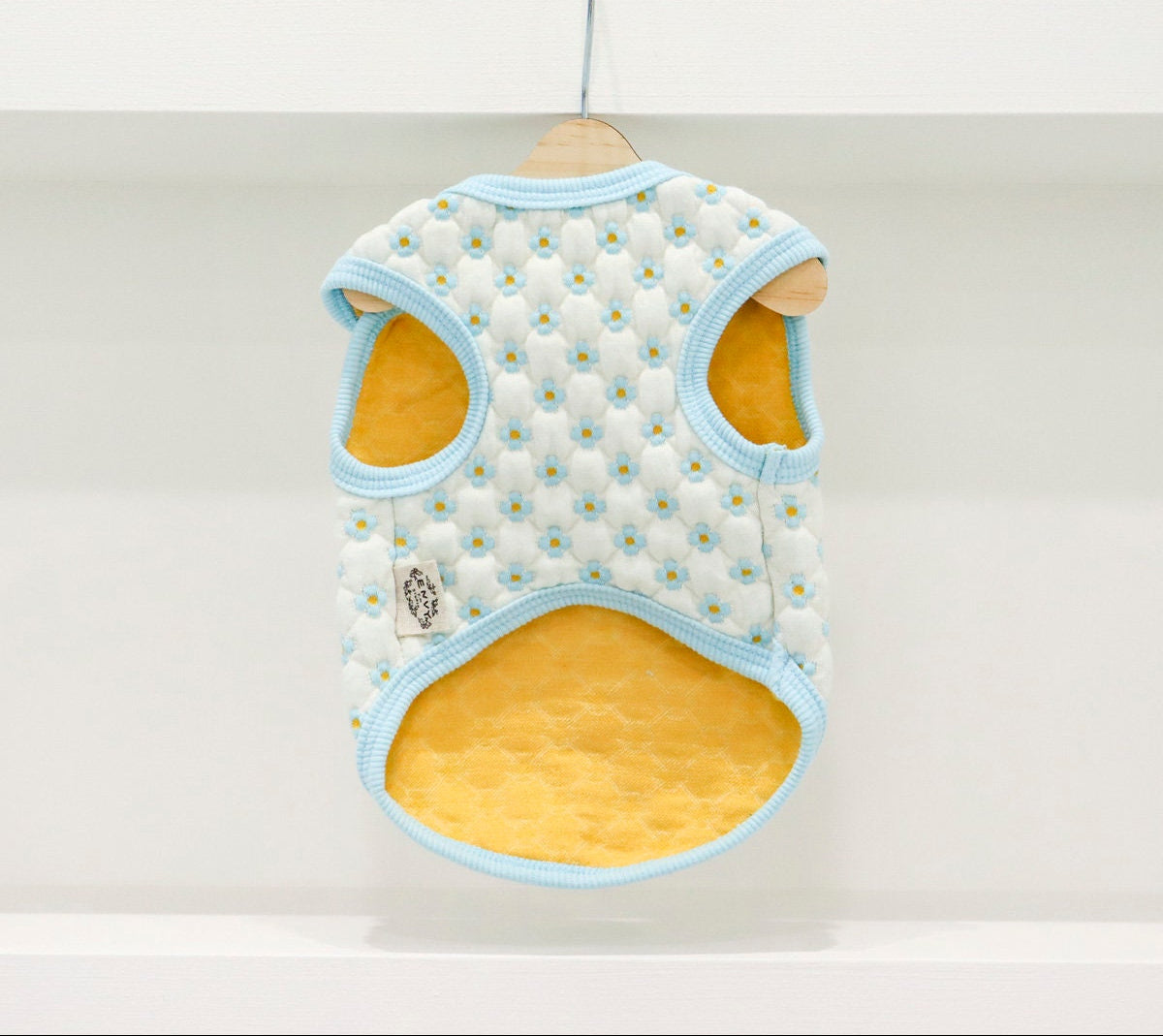 NKpup Daisy Quilted Dog Vest in white with light blue daisy pattern and yellow lining