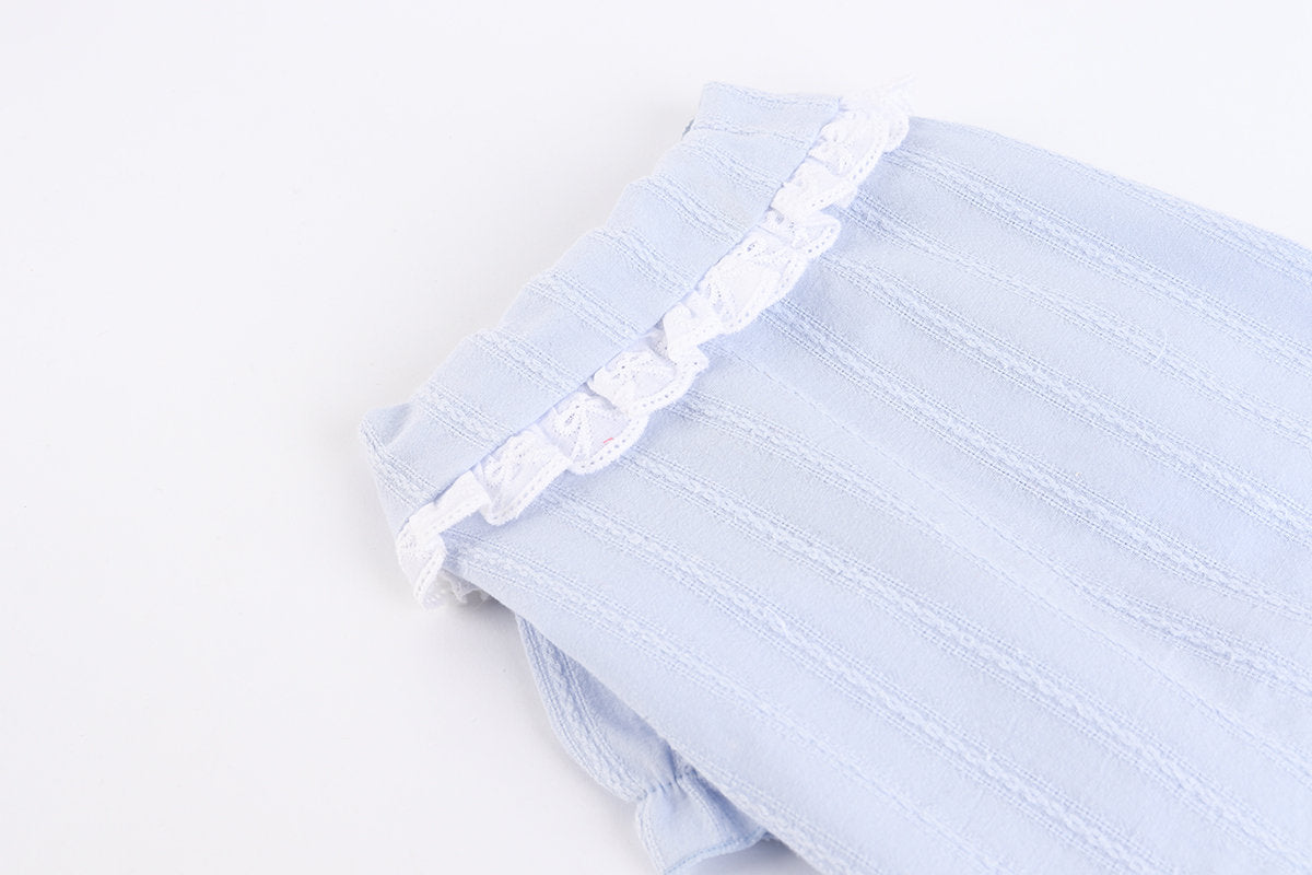 Light blue lace puff blouse with white lace trim detailing.