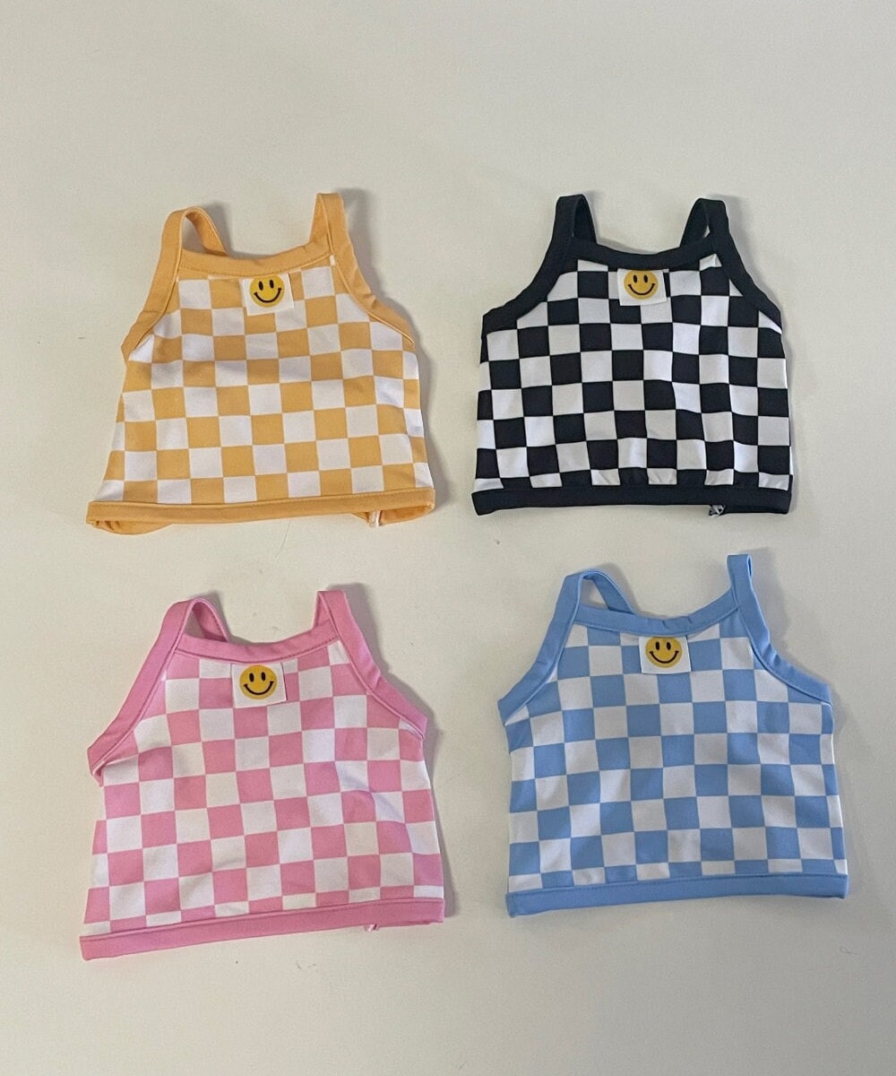 Four cooling check crop top dog shirts in yellow, black, pink, and blue checkered patterns.