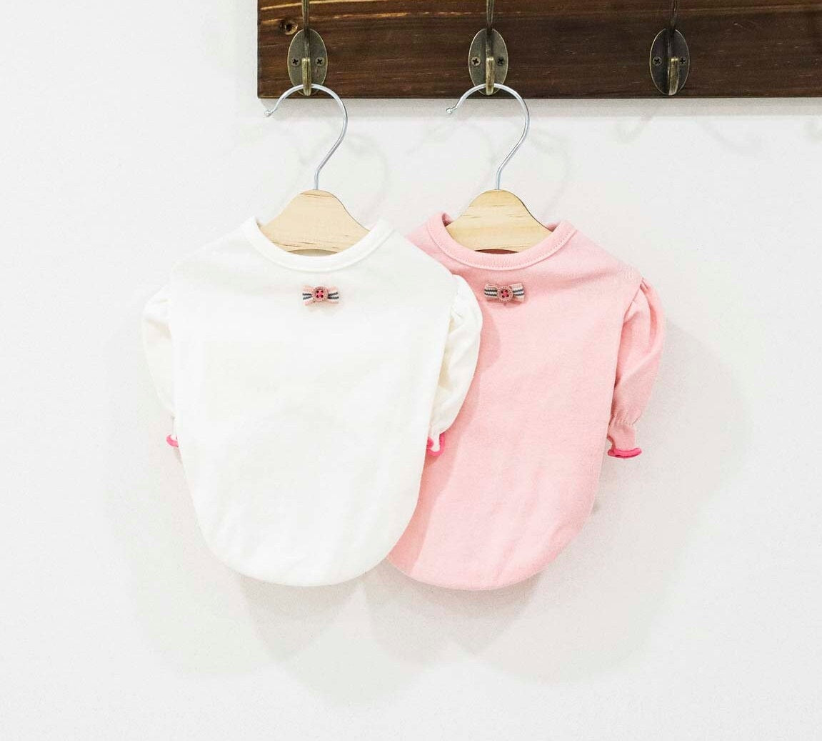 Two NKpup puff sleeve pet t-shirts, one white and one pink, with decorative bows.