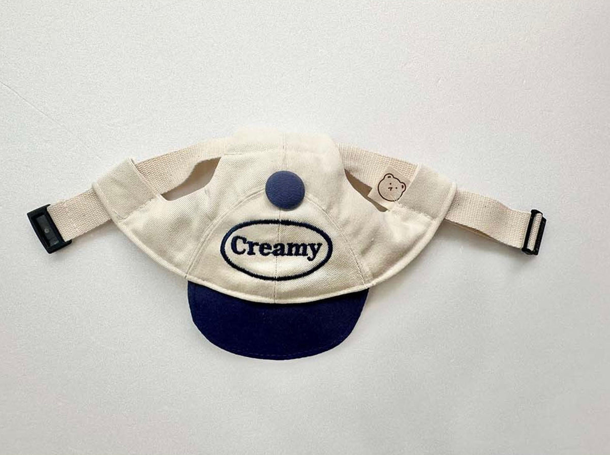 Creamy dog cap hat by NKpup in cream and navy blue with Creamy embroidery.