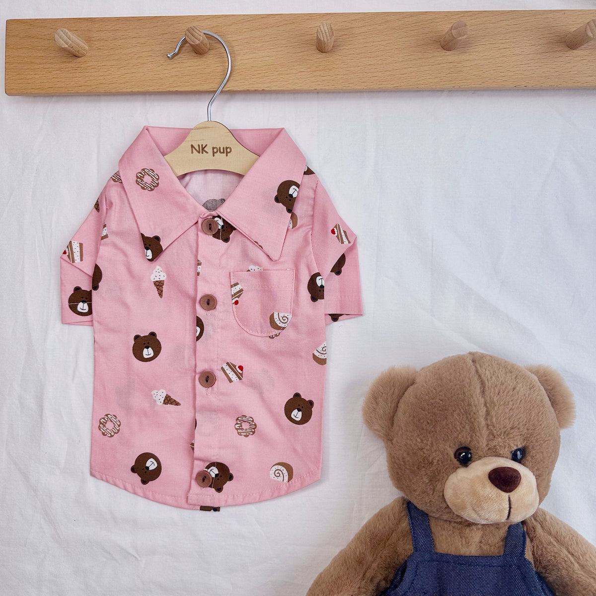 Pink NKpup dog shirt featuring a sweet treats and bear pattern.