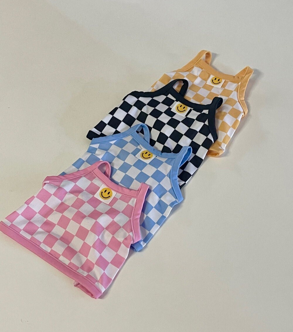 Set of four NKpup cooling check crop top dog shirts in pink, blue, black, and yellow with smiley face details.