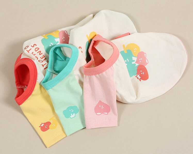 Set of NKpup veggie color block dog shirts in yellow, mint, pink, and white with vegetable patterns.