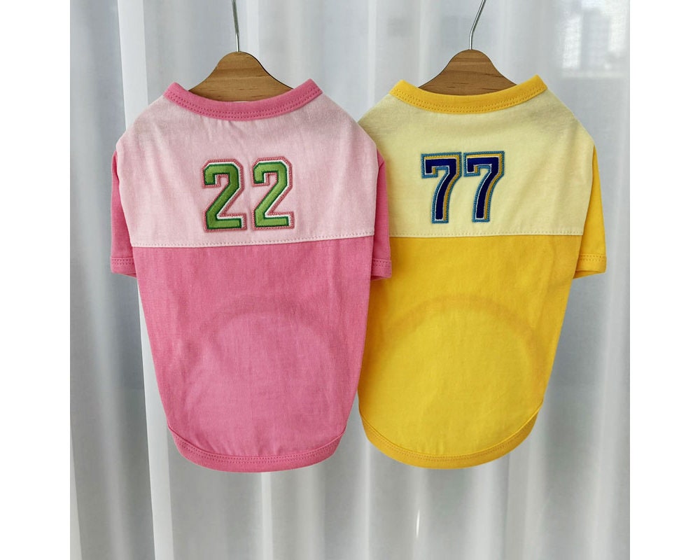 NKpup color-block dog shirts in pink and yellow with numbered patches