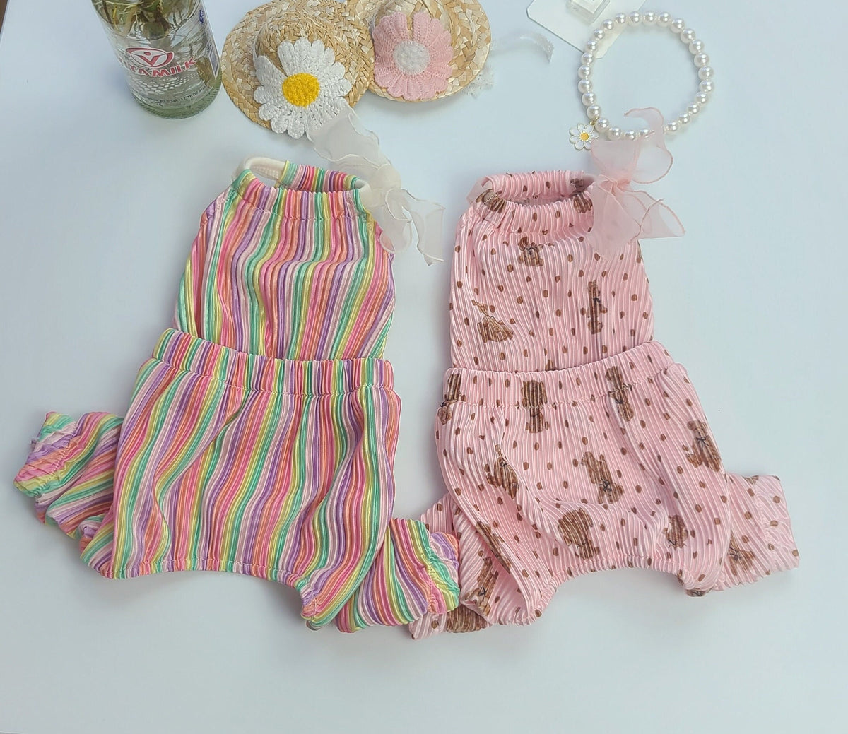 Bali Ribbon Dog Overalls in colorful rainbow stripes and pink patterned fabric.