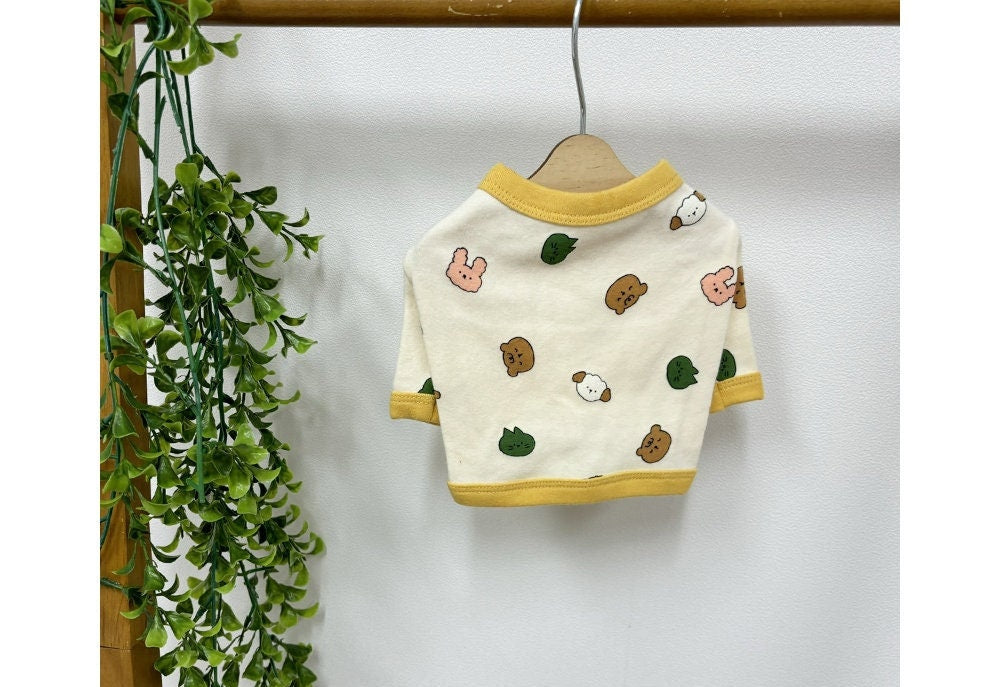 NKpup Zoo Crop Top white dog shirt with colorful animal character patterns and yellow trim