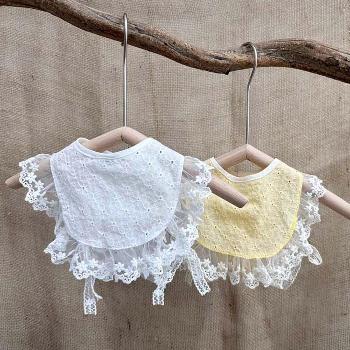 Two cotton lace bibs for pets, one white and one pale yellow, featuring delicate lace trim.
