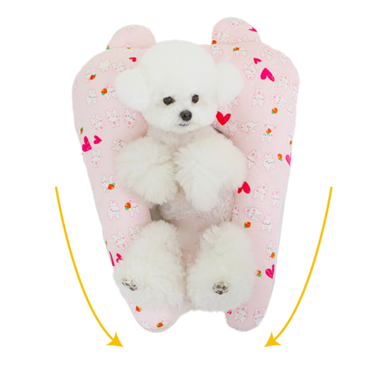 White Bichon Frise dog resting on a pink NKpup dog summer cooling hug pillow cushion with heart patterns.