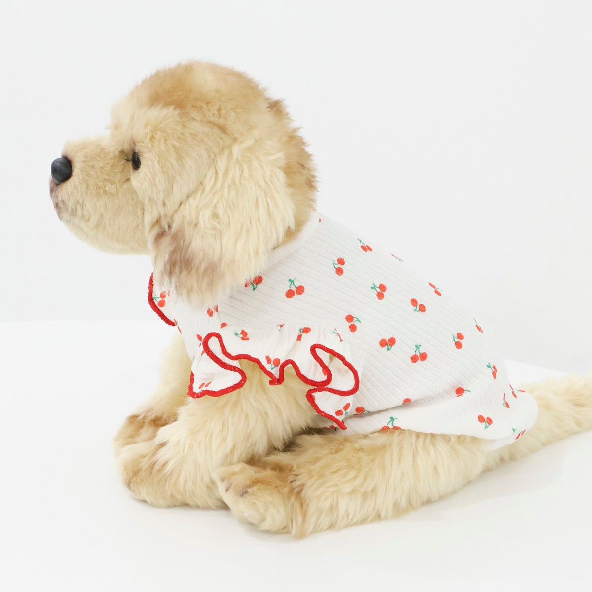 White ribbed dog shirt with a red cherry pattern and ruffled trim.