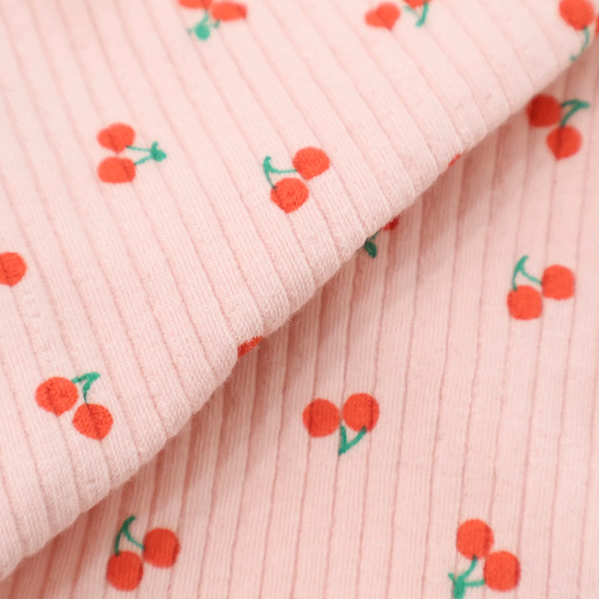 Pink ribbed fabric with a red cherry pattern for the Cherry Ribbed T-Shirt by NKpup