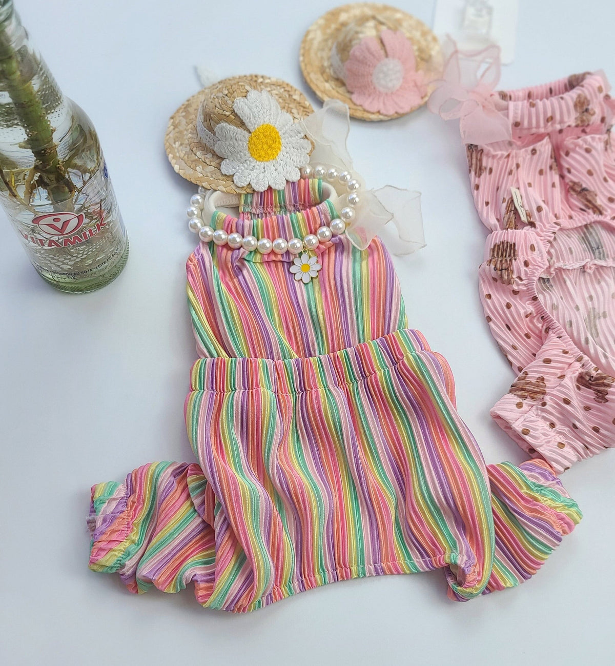 Bali Ribbon Dog Overall in colorful vertical stripes with a pearl collar and daisy detail