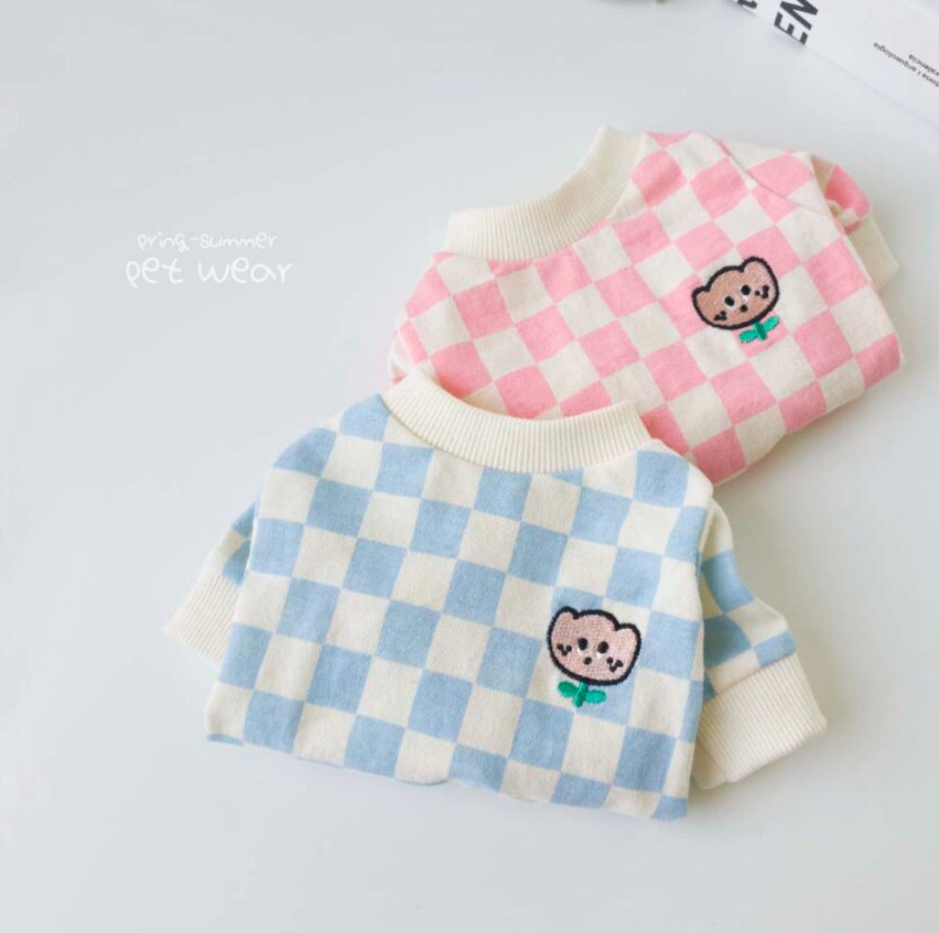 Two NKpup checkerboard tulip dog shirts in pink and blue with cute bear embroidery.