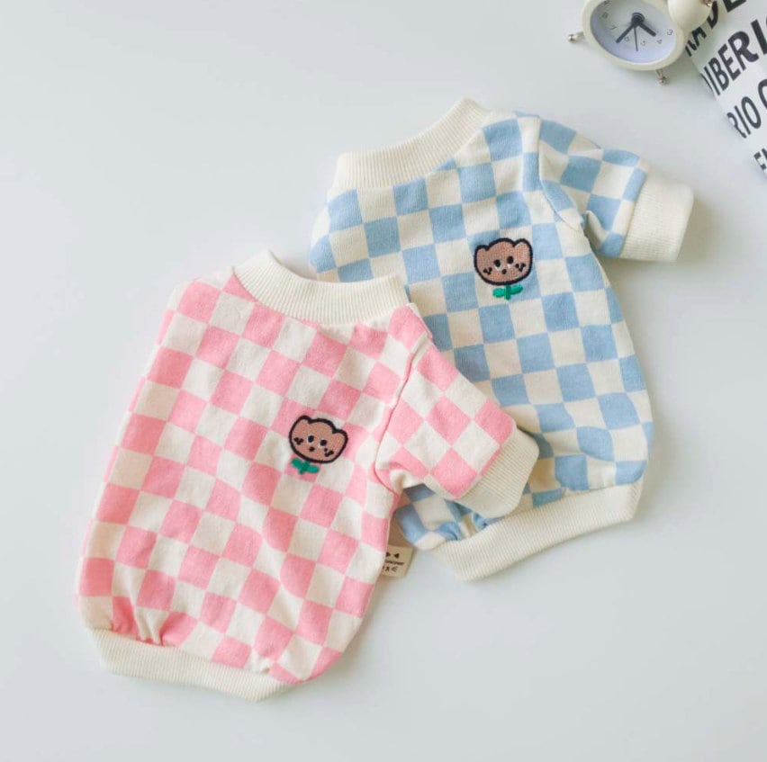 Two NKpup checkerboard tulip dog shirts in pink and blue with cute bear embroidery.