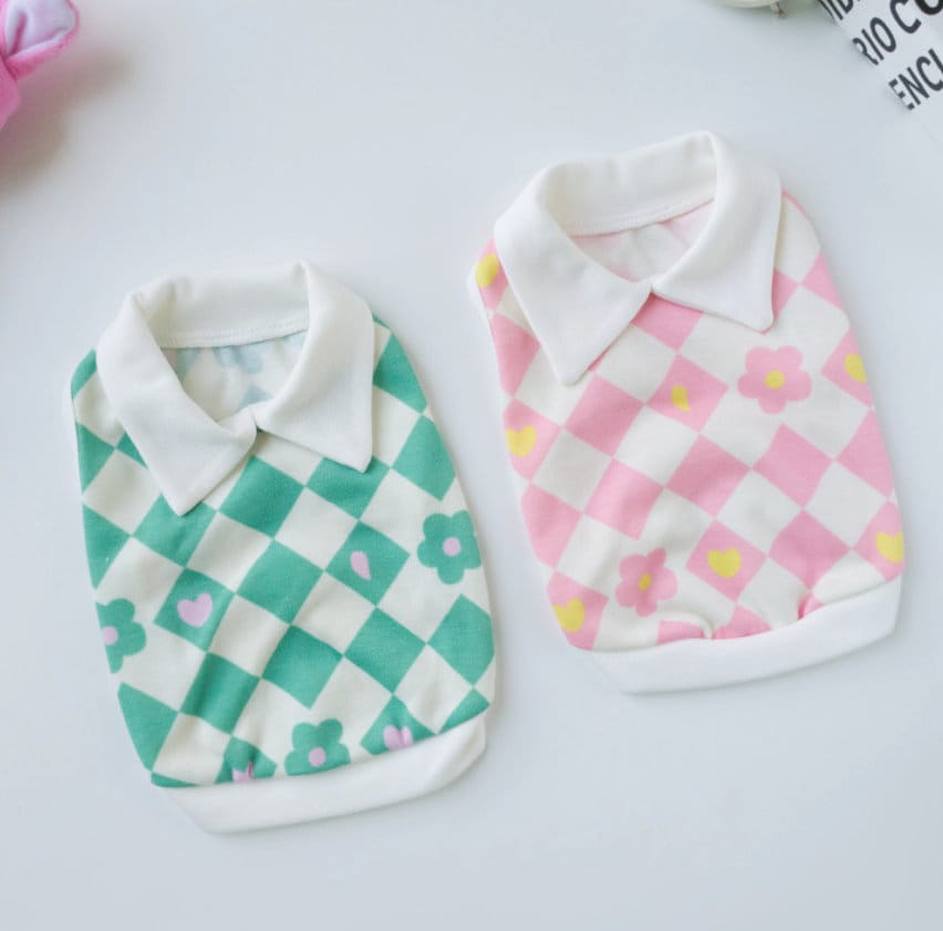 Two NKpup checkerboard flower dog shirts with collars in mint green and pink colors.