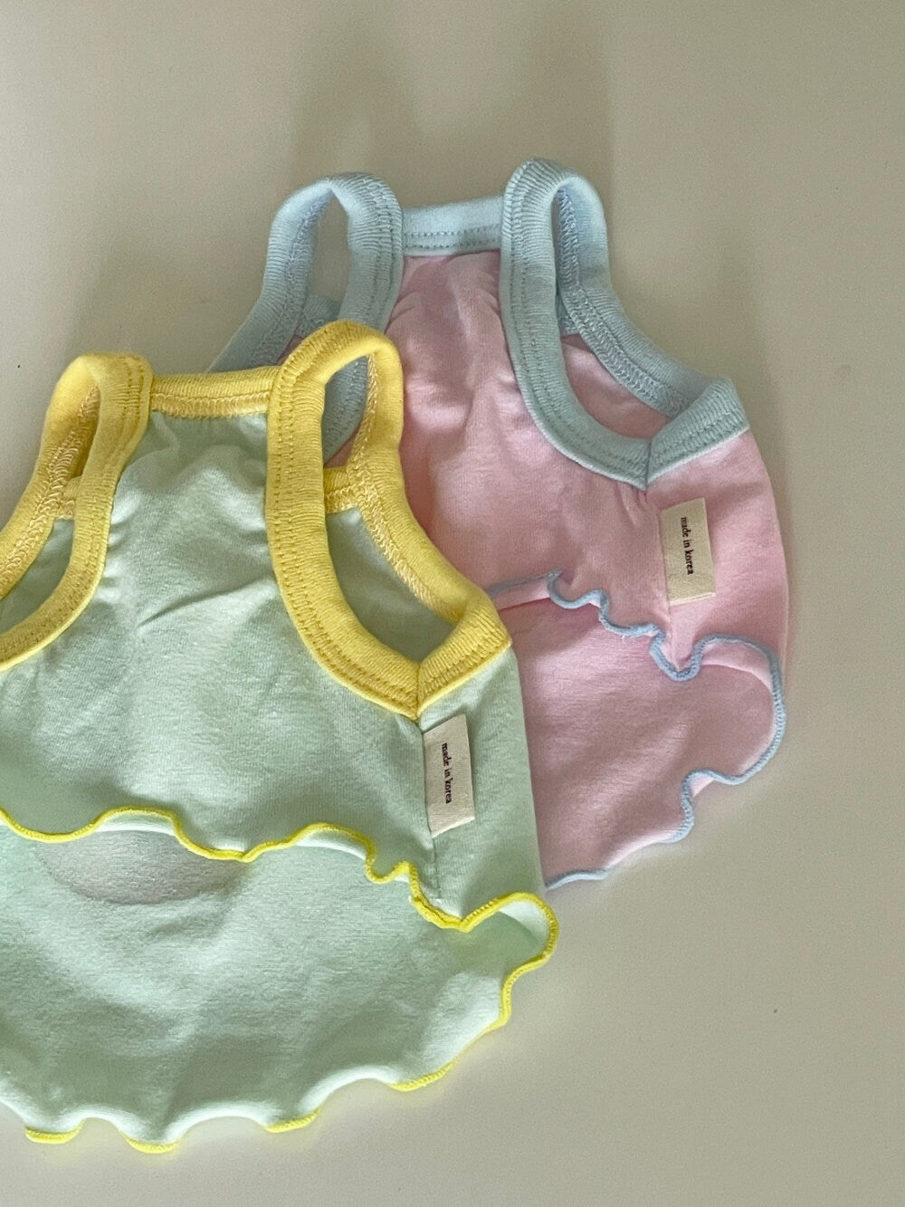 NKpup Animal Ribbon Dog Tank Tops in mint green with yellow trim and light pink with blue trim.
