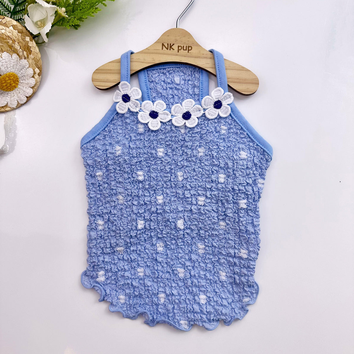 NKpup Daisy Ruffle Dress in light blue with white floral daisy embroidery.
