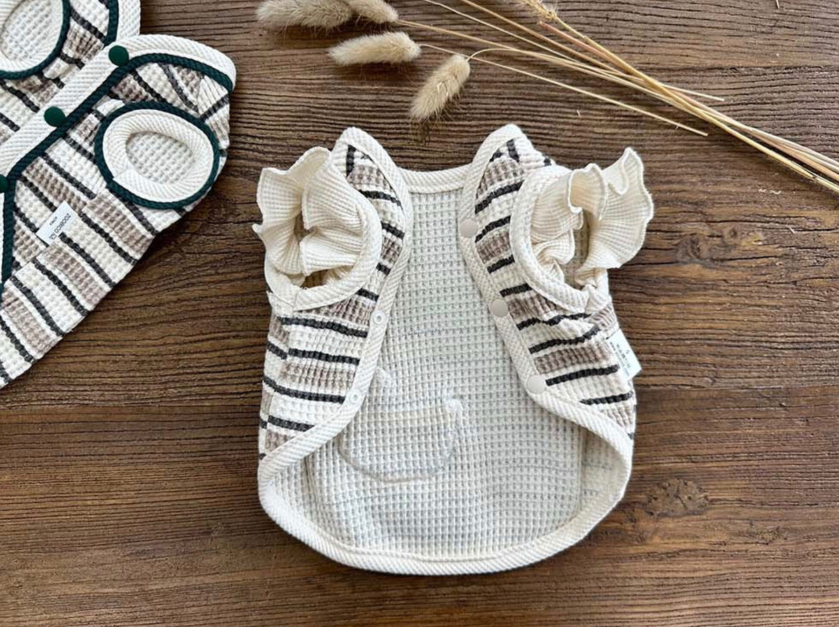 Waffle Stripe Dog Vest in cream and black with ruffled sleeves.