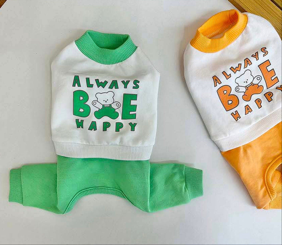 Always Be Happy dog overall in white, green, and orange with bear graphic print.