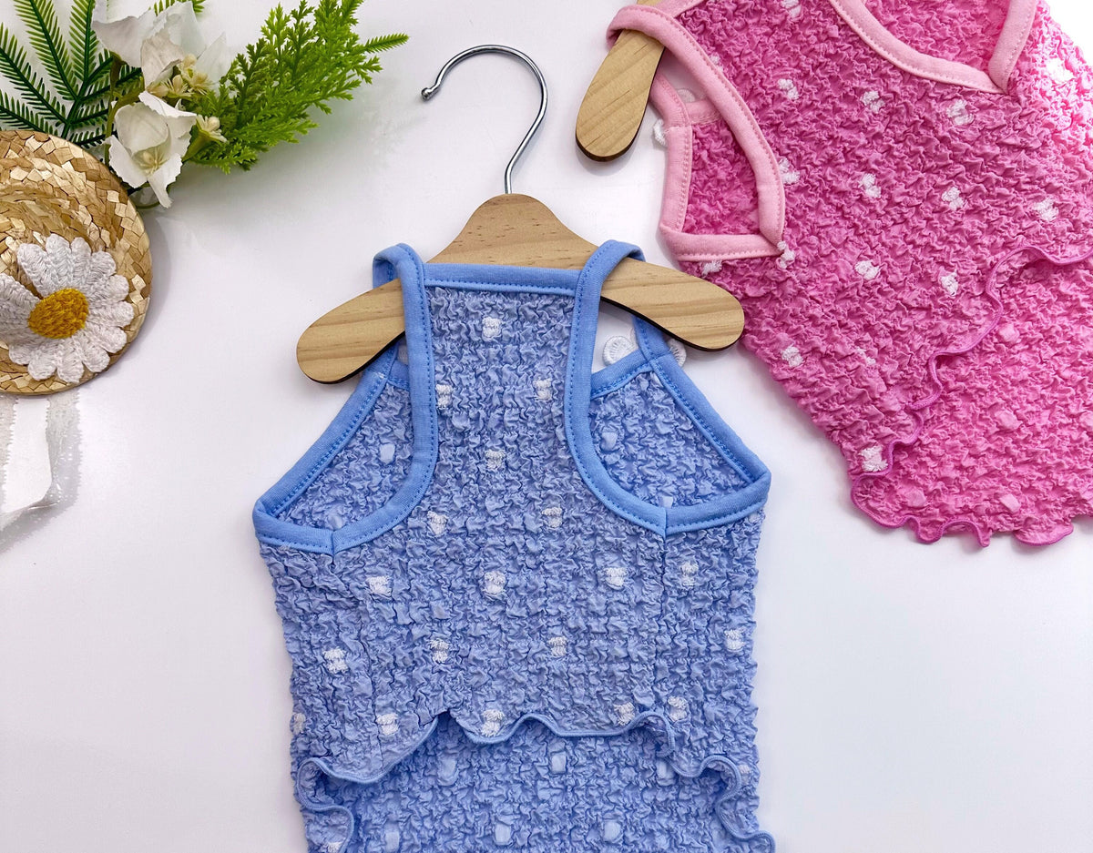 Blue and pink Daisy Ruffle Dog Dresses with white polka dot patterns.