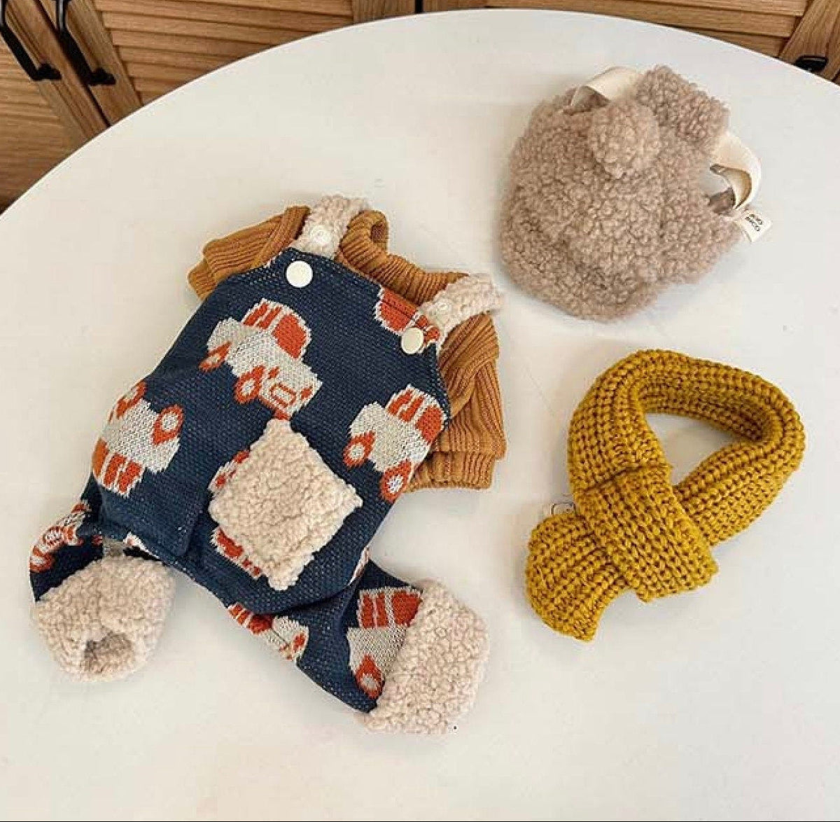 NKpup navy blue dog suspender overalls with orange truck pattern, brown sweater, hat, and scarf