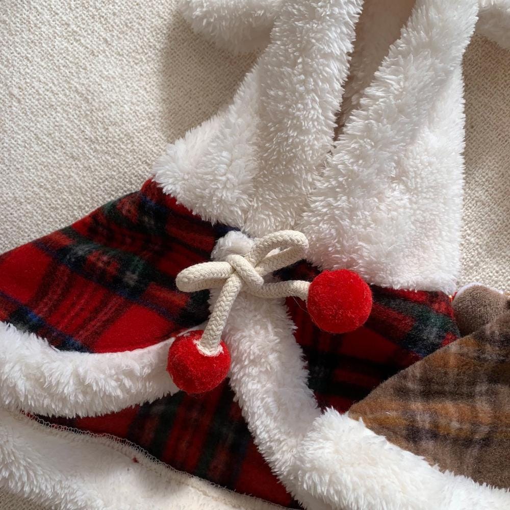 Christmas plaid dog hoodie cape with red and green pattern and white faux fur trim.
