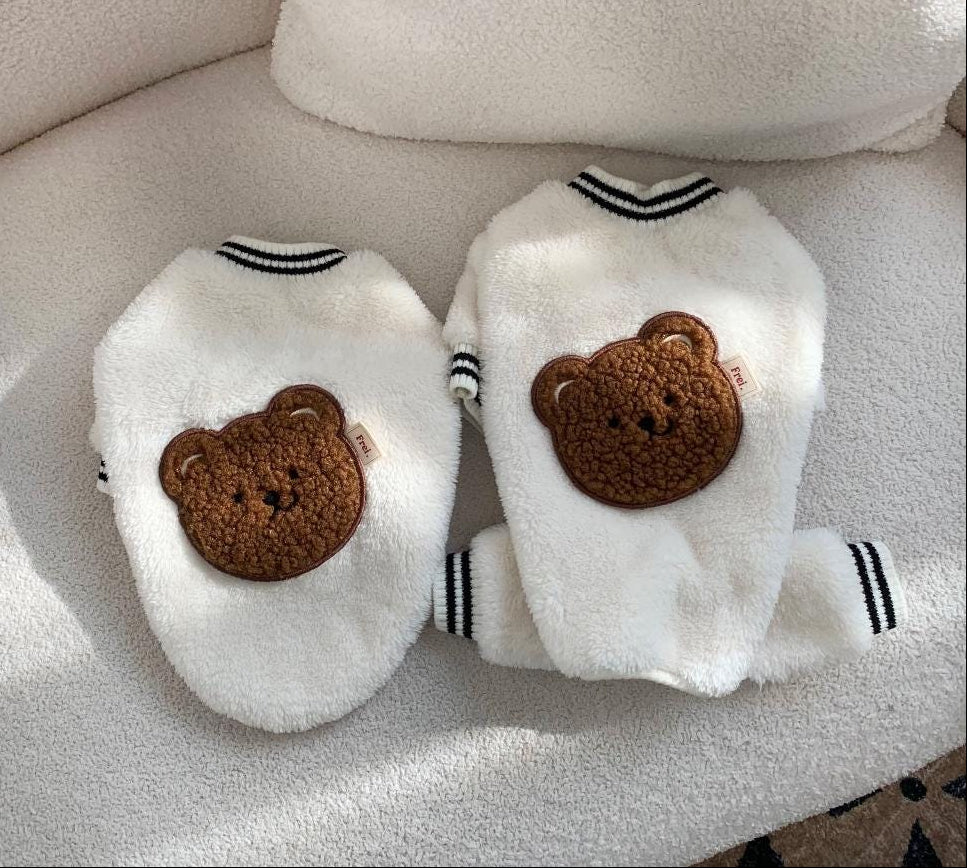 White NKpup teddy bear fleece dog sweatshirt and overall set with brown bear patches.