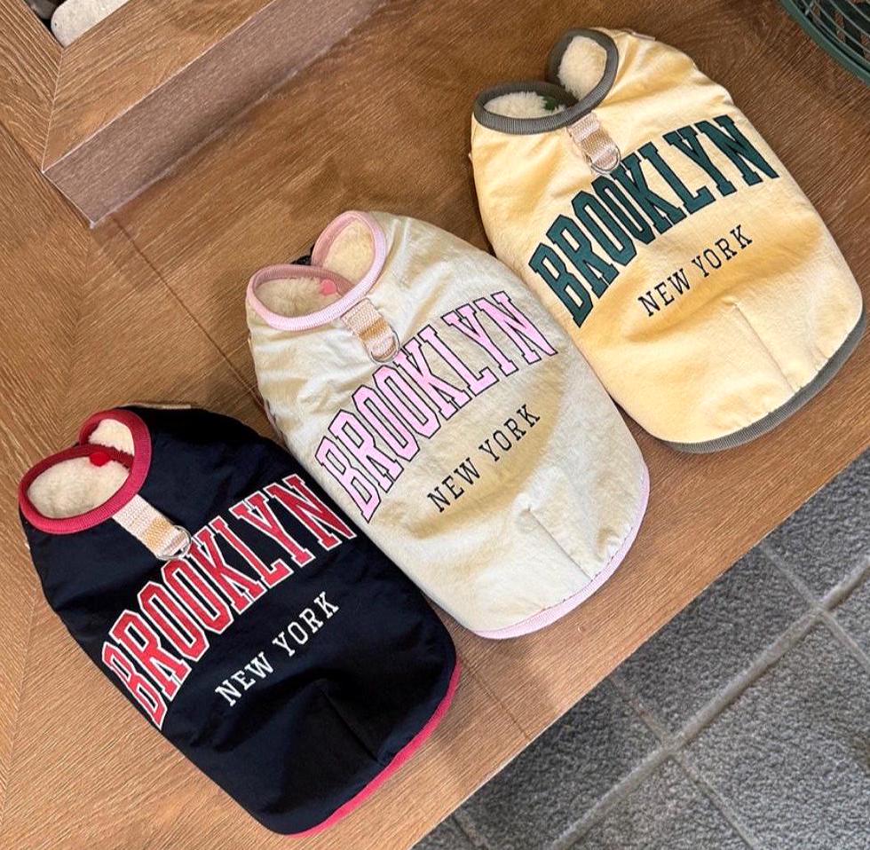 Three Brooklyn D-Ring Padded Dog Vests in black, cream, and yellow colors.