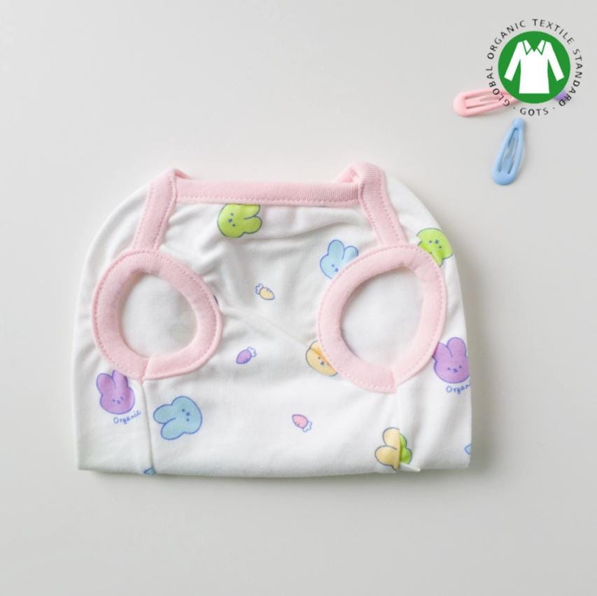 White GOTS organic dog shirt with a colorful bunny pattern and pink trim.