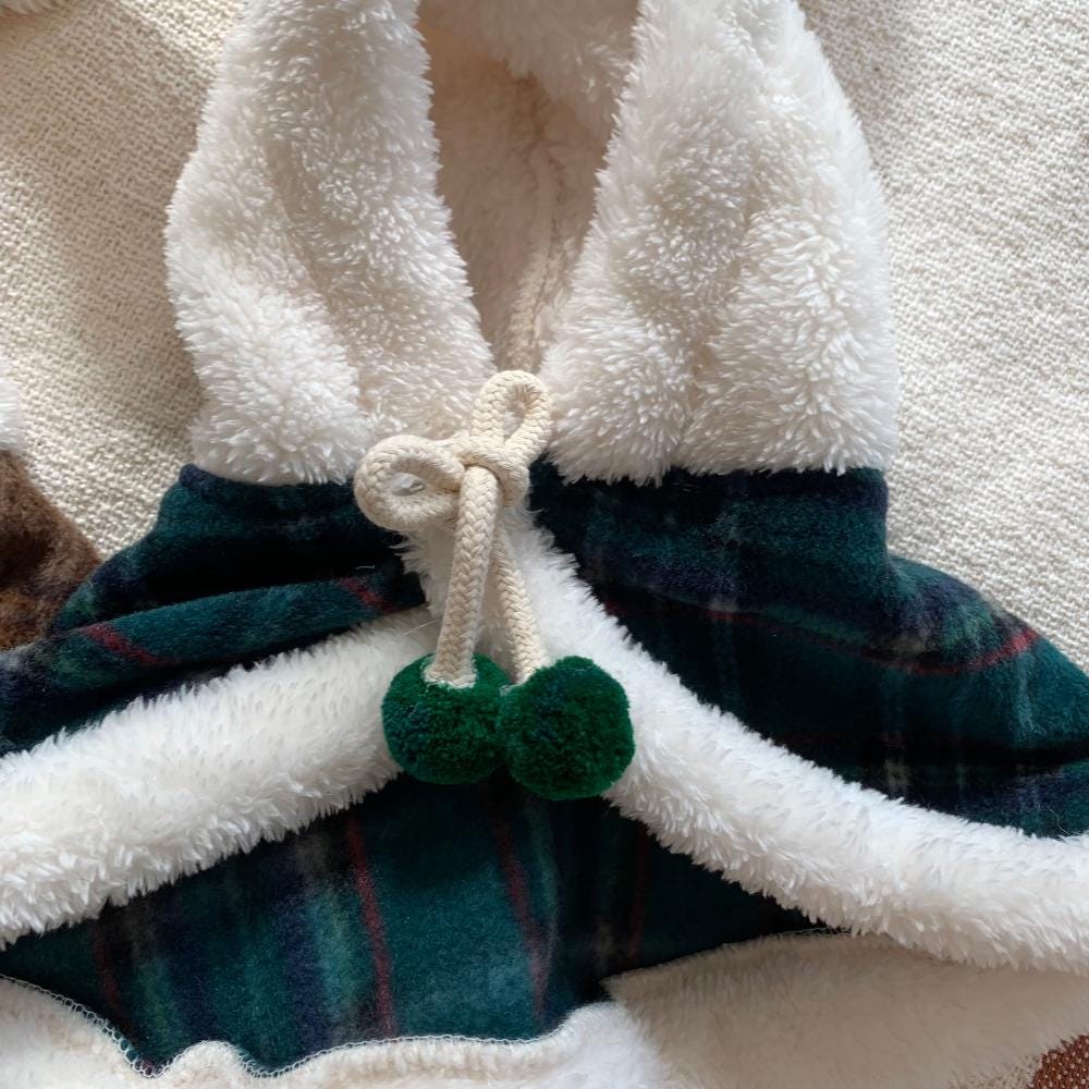 Christmas plaid dog hoodie cape with white faux fur trim and pom-pom drawstring.