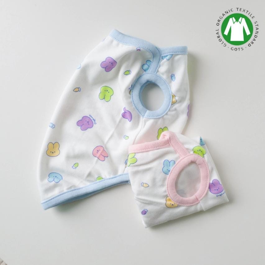 Two white GOTS organic bunny patterned dog shirts with light blue and pink trim.
