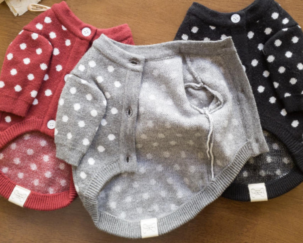 Three NKpup polka dot knit dog cardigans in red, grey, and black.