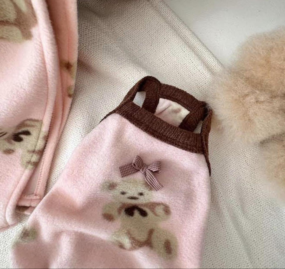 Pink NKpup Teddy Fluffy Dog Overall featuring a bear graphic and brown bow detail.