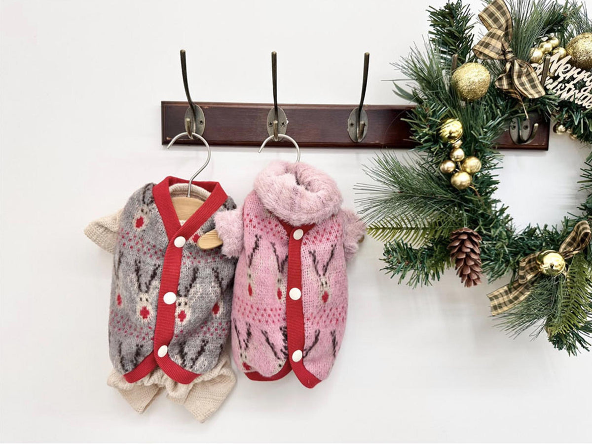 Christmas reindeer knit dog vests in grey and pink with red trim.