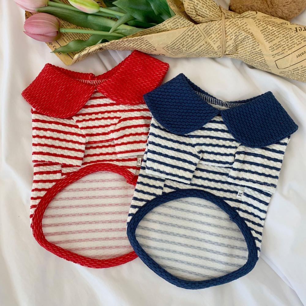 Two NKpup collared striped dog shirts, one in red and white and the other in navy and white.