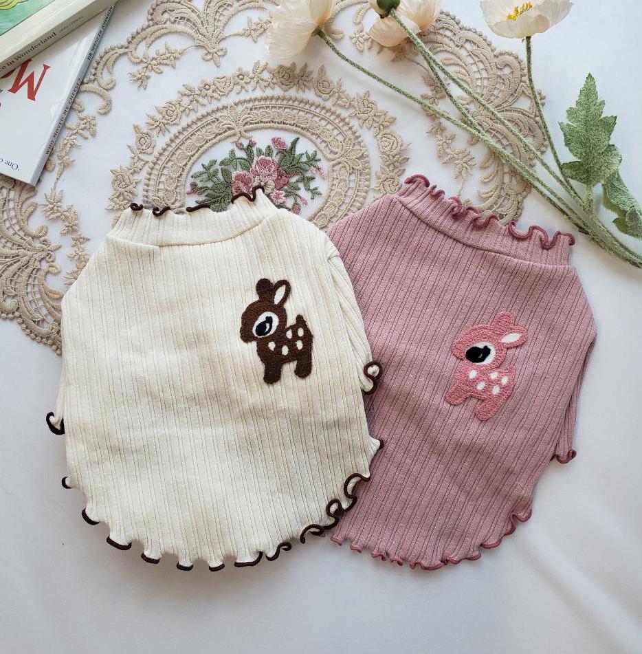 Two frilly deer ribbed dog tees in cream and dusty pink with cute deer patches.