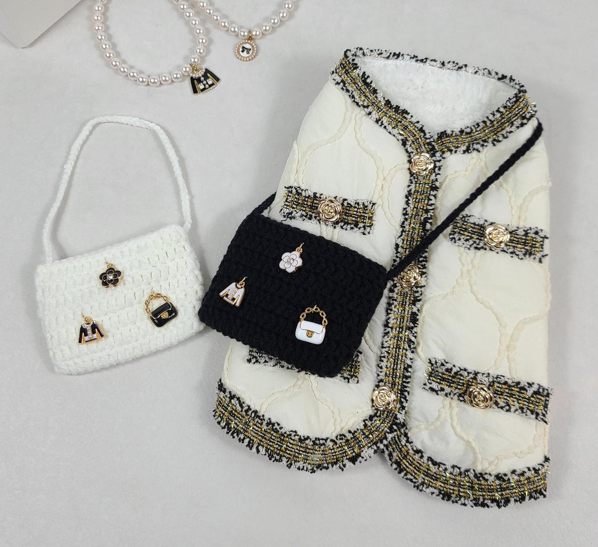NKpup white quilted tweed dog vest with gold trim and a black crossbody mini bag.