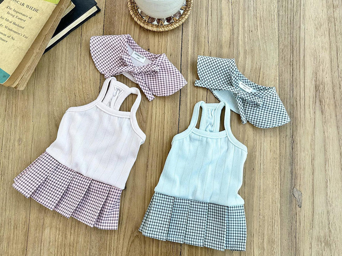 Set of three NKpup gingham collar pleated dog dresses in pink, light blue, and black and white.