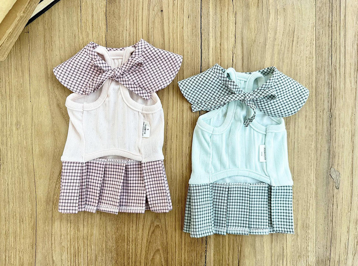 Two NKpup gingham collar pleated pet dresses in pink and mint green.