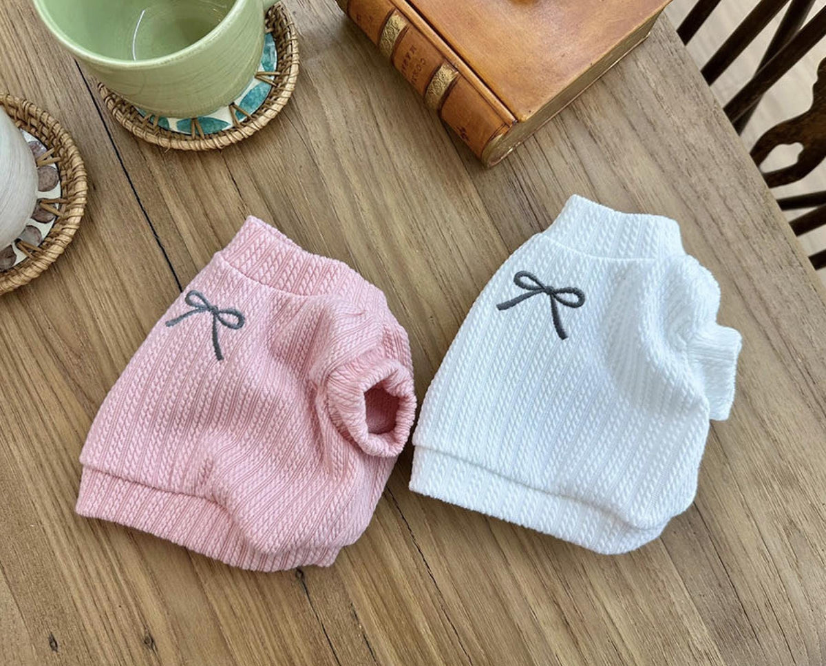 Pink and white NKpup eyelet crop top dog shirts with small bow accents