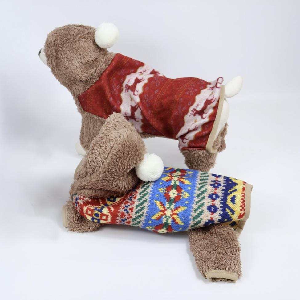 NKpup Nordic Bear Dog Overall in red with a festive reindeer pattern.